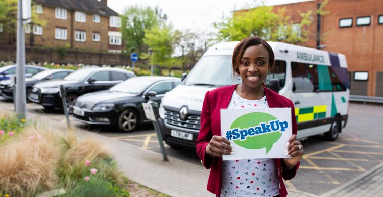 lady holding Speak Out Card