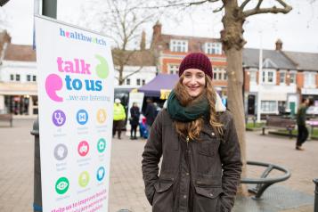 Lady stood next to a Healthwatch banner