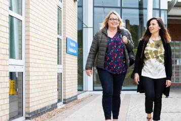 Two women outside hospital